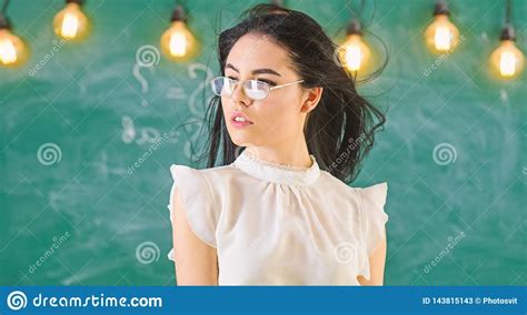 Woman With Long Hair In White Blouse Stands In Classroom Teacher With