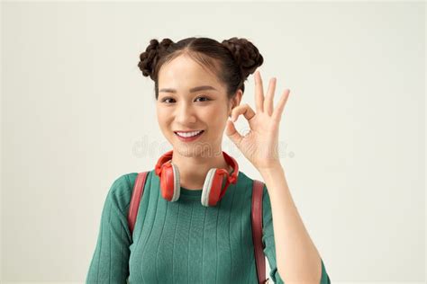 Happy Student Showing Okay Gesture While Smiling At Camera Isolated On