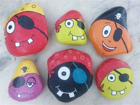 Five Painted Rocks With Cartoon Faces On Them