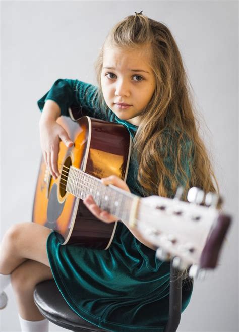 Download Little Girl In Dress Playing Acoustic Guitar For Free