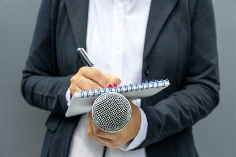 Female Journalist At Media Event Or News Conference Writing Notes