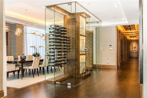 Glass Enclosed Wine Cellar With A Stone Wall By Papro Consulting Featuring The Cable Wine System
