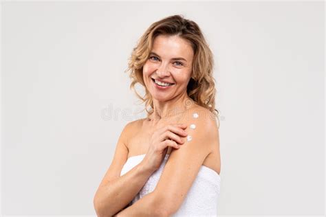Skin Nourishing Smiling Beautiful Middle Aged Lady Applying Body