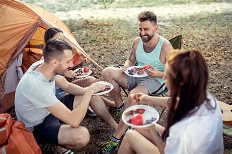 Party Camping Of Men And Women Group At Forest They Relaxing And Eating Barbecue Stock Image
