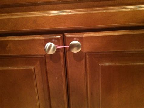 Childproof Cabinet Doors Using Hair Ties Parenting Hacks