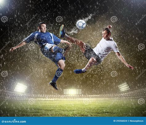 Two Football Players Striking The Ball Stock Photo Image Of Blue