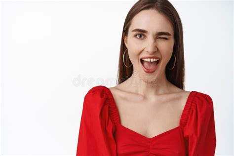 Close Up Of Positive Brunette Girl In Red Dress Smiling Winking And
