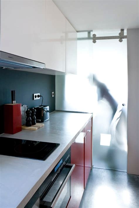Custom glass shelves, glass handrail, and table/desk tops. Architects Create 130-Square-Foot Studio