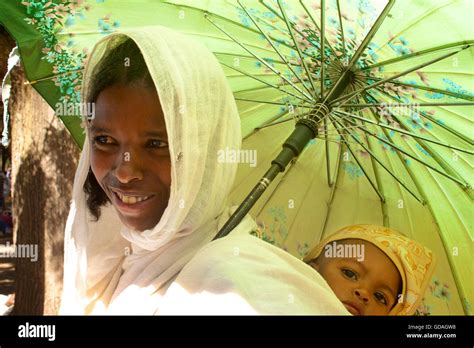 Mother And Baby Child Under A Parasol Axum Tigray Ethiopia Stock