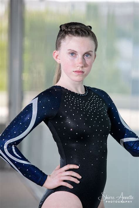 A Woman In A Black And Blue Leotard With Her Hands On Her Hips