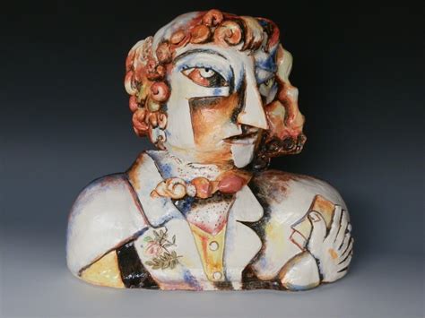 A Ceramic Busturine Of A Man Wearing A Suit And Tie With Flowers In His Hair