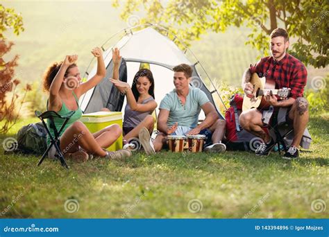 Happy Young People Having Fun With Music On Camping Trip Stock Photo