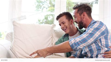 Gay Couple Relaxing On The Couch Using Laptop Stock Video Footage 8121833
