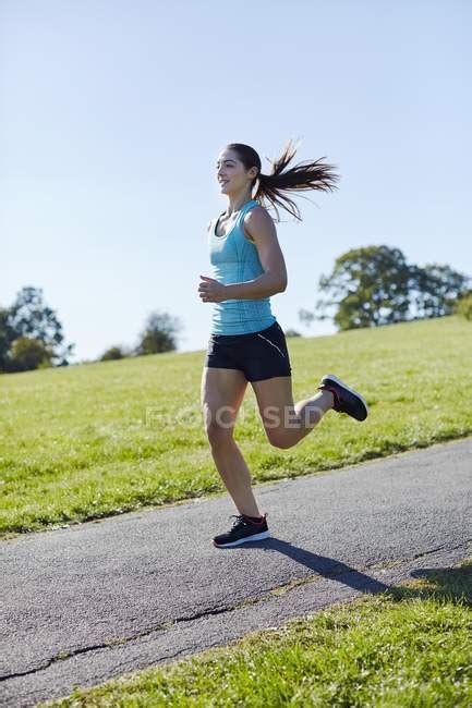 Young Woman Jogging On Park Path — Exercising One Stock Photo