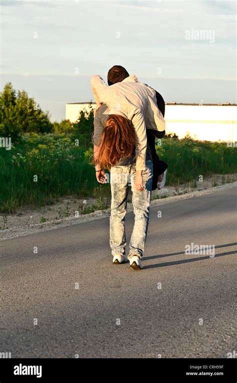 Man Carrying A Young Woman On His Shoulder Stock Photo Alamy