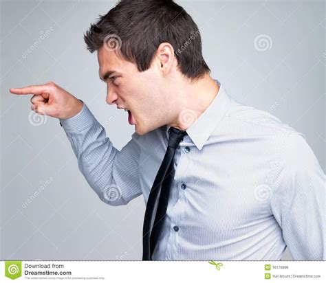 Angry Young Business Man Screaming And Pointing Stock