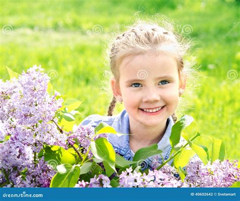 Portrait Of Adorable Smiling Little Girl On The Meadow Stock Photo