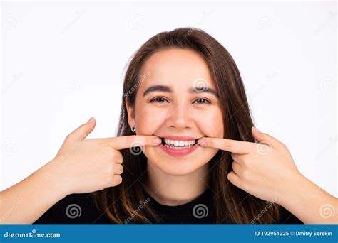 Pretty Woman Stretching The Corners Of Her Mouth And Making Smile Stock