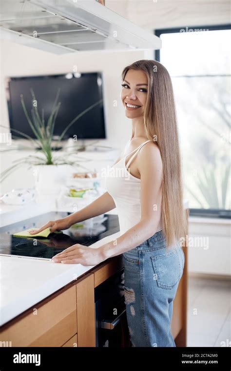 Beautiful Woman Doing Cleaning At Home At Kitchen Stock Photo Alamy