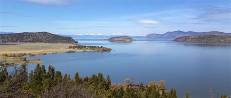 Upper Klamath Lake With The Snow Peaked Rim Of Crater Lake In The