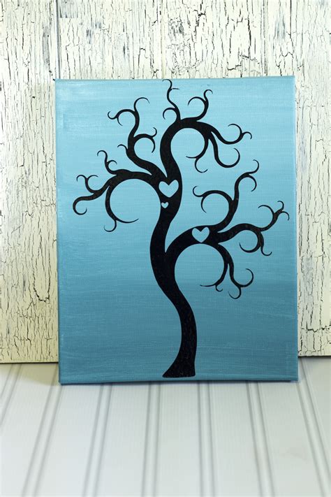 This design is a great way to fill a wall with a collage of photos. DIY Canvas Tree Wall Art - Life. Family. Joy