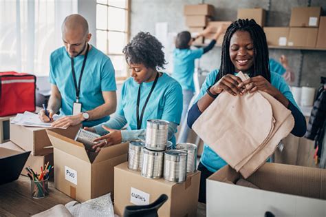 Food bank volunteers work for charities and are responsible for serving people included in social support programs. Diverse Volunteers Packing Donation Boxes In Charity Food ...