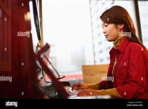 Young Woman Playing The Piano Stock Photo Alamy