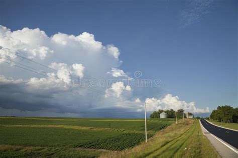 Rural Midwest Road And Fields Under Big Clouds Stock Image Image Of