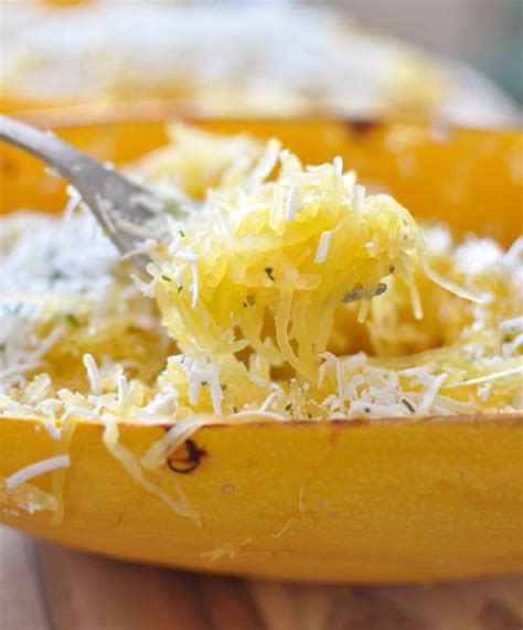 A Spoon Full Of Grated Cheese In A Yellow Bowl
