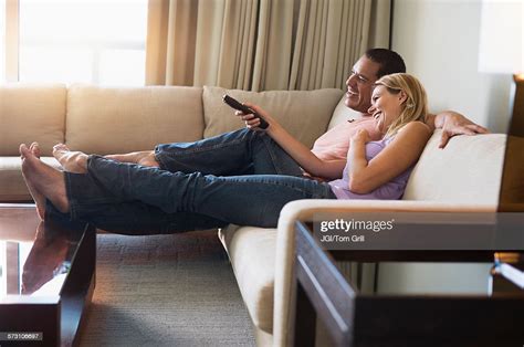 Couple Watching Television On Sofa Photo Getty Images