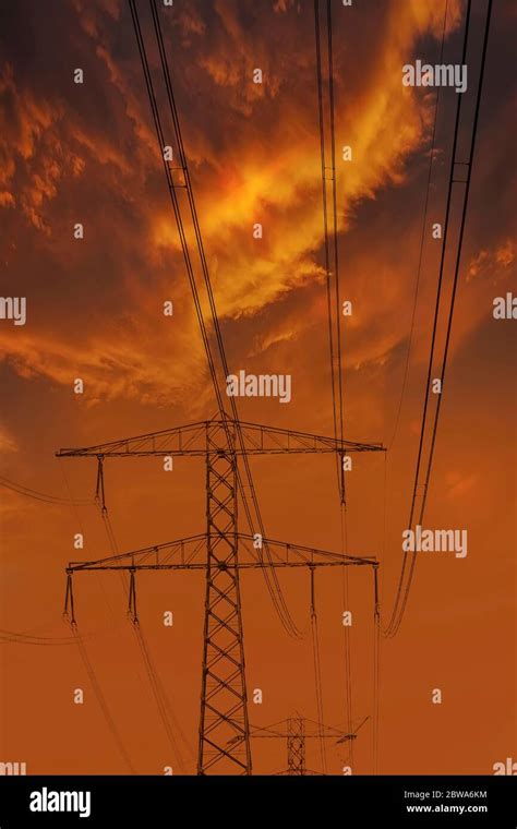High Voltage Power Lines Electricity Pylons At Sunset Stock Photo Alamy