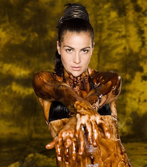 Young Brunette Girl On Bright Background Covered Chocolate Cream All Over Her Body And Face
