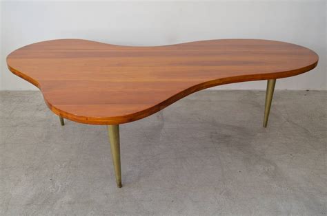 The mass produced coffee table noguchi designed for herman miller appears to have evolved out the noguci table was introduced in 1945 and produced until 1973. T.H. Robsjohn-Gibbings Maple and Brass Biomorphic Coffee ...