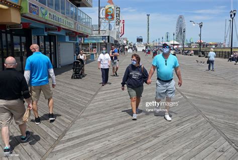 People Traverse The Seaside Heights Boardwalk As The State Begins To