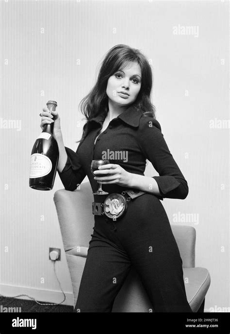 Actress Madeline Smith Holding A Glass Of Wine And Bottle Of Champagne