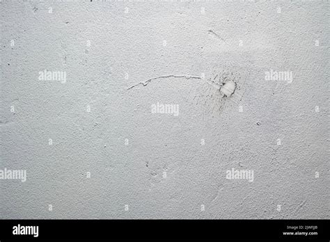 Texture Of An Old Plastered White Wall With Deep Scratches And Cracks