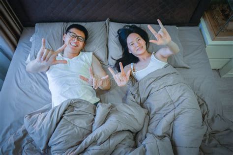 Happy Asian Couple In Love Sleeping Together On Bed Stock Image