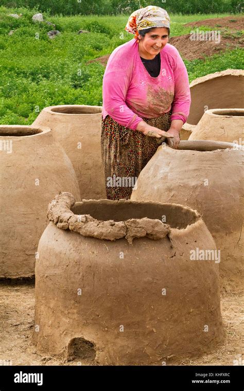 Woman Making Tandoor Ovens Using Mud And Clay In Diyarbakir Turkey