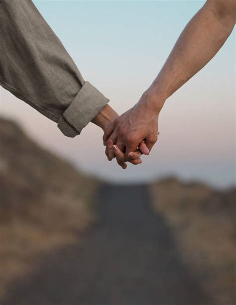 Download Couple In Love Holding Hands Wallpaper