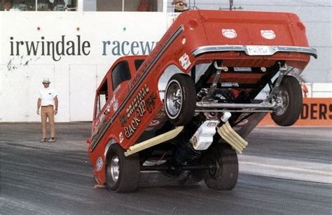 A Red Truck With Its Front Wheels Off The Ground