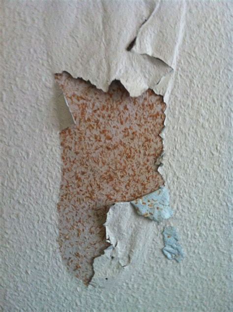 Layers Of Paint Are Peeling Off The Wall Exposing The Layers Of Paint