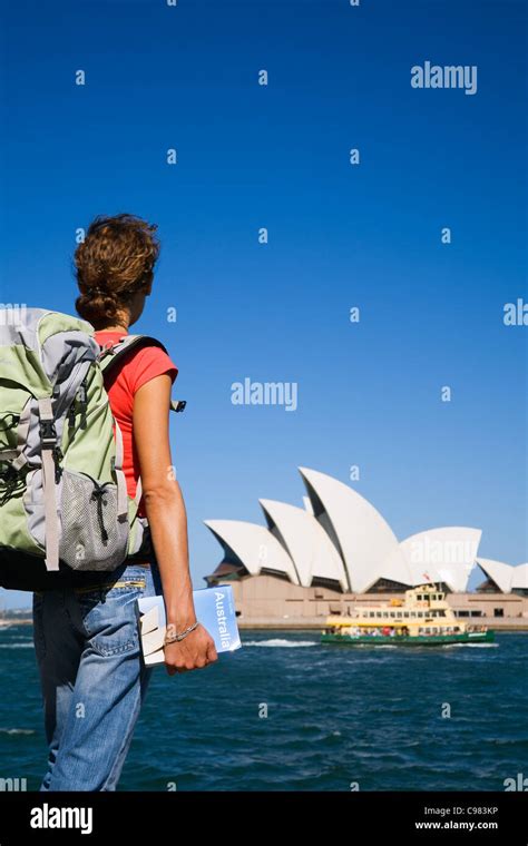 Backpacker Holding Guidebook With Sydney Harbour In Background Sydney