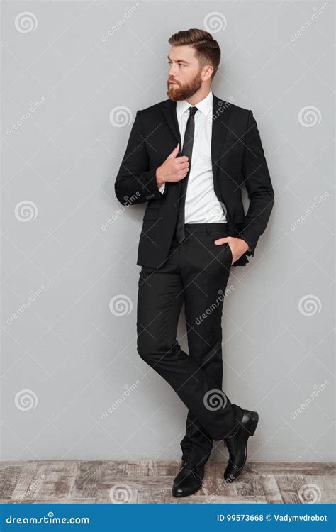 Stylish Handsome Businessman In Suit Posing While Standing Stock Photo