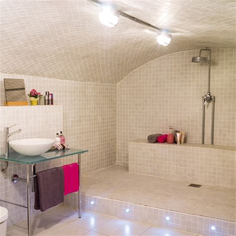 The only way to entirely prevent spotting and soap scum to wipe down the shower door after every use. Open Shower Bathroom Design with Arched Ceiling