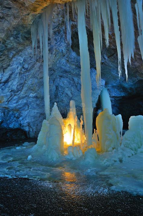 Ice Stalagmites And Stalactites Illuminated By Candles And Fluorescent