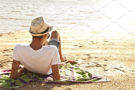 Young Man Lying On The Beach Stock Photo Containing Beach And Vacation