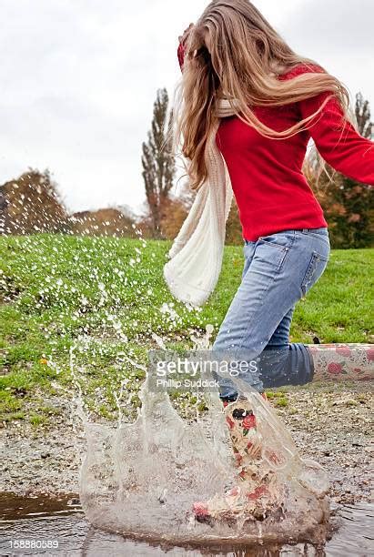 Woman Jumping In Rain Puddle Photos And Premium High Res Pictures