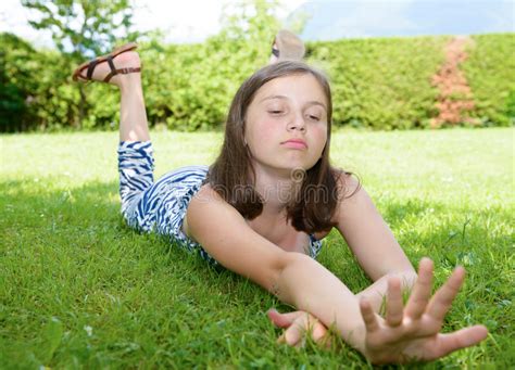 We go the extra mile for our families. Pretty Pre Teen Girl Lying In Grass Stock Photo - Image of ...