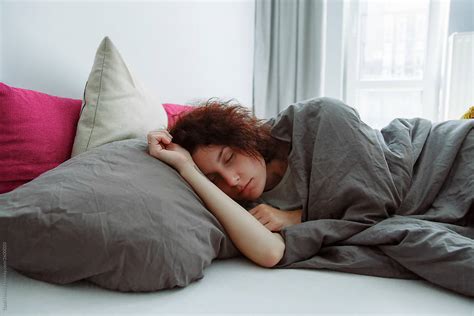 Tired Female Sleeping In Bed Del Colaborador De Stocksy Danil Nevsky