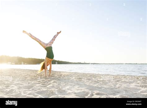 Young Girl Doing Handstand On The Beach Stock Photo Alamy